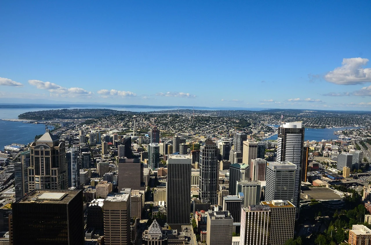 An elevated view of downtown Seattle with Elliott Bay and Lake Union beyond